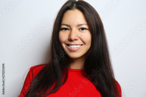 Photos Attractive young woman posing on light background