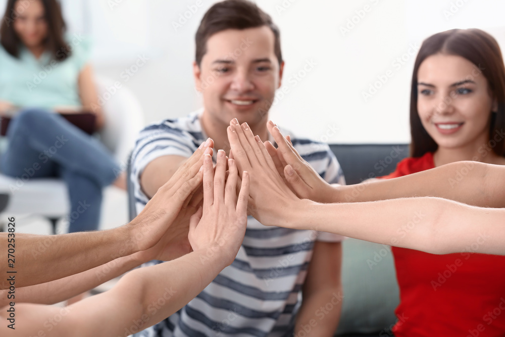 People putting hands together indoors. Unity concept People putting hands together indoors. Unity concept