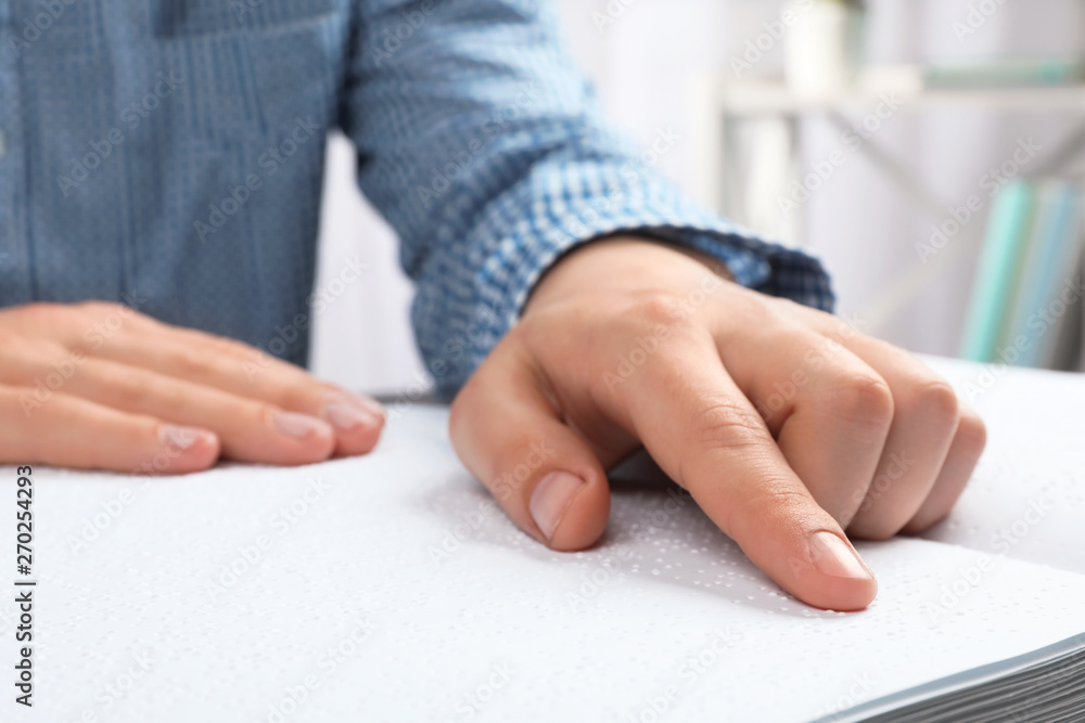 Blind person reading book written in Braille, closeup Blind person reading book written in Braille, closeup