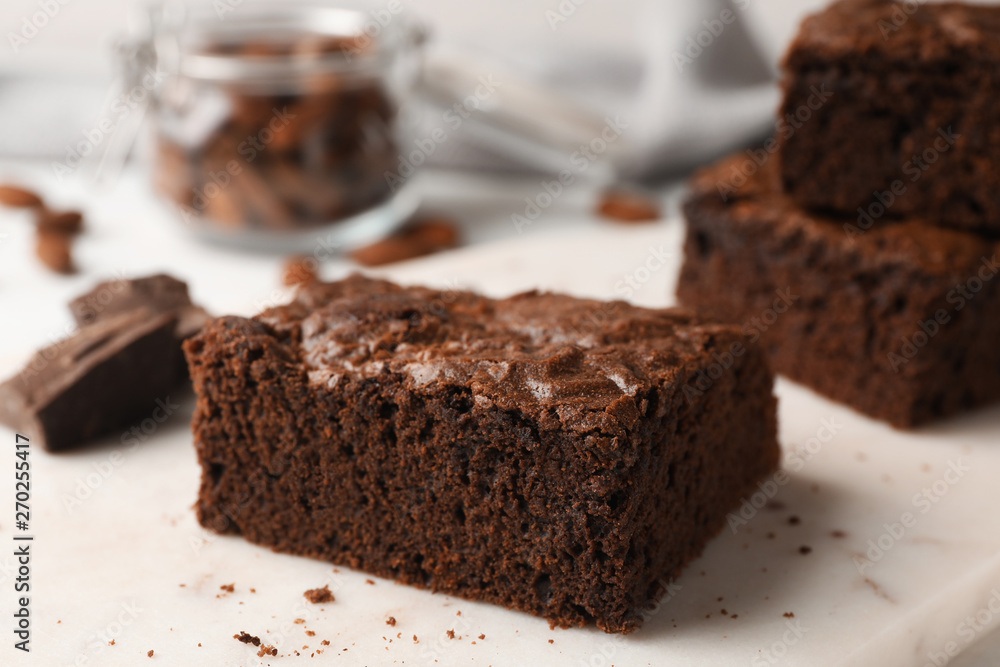 Serving board with fresh brownies on table. Delicious chocolate pie