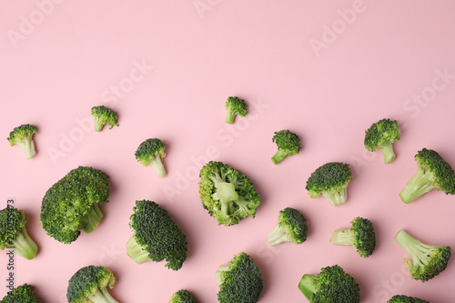 Flat lay composition with fresh green broccoli on color background