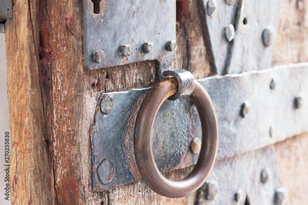 Iron door handle of a medieval wooden door (Germany, Europe) Iron door handle of a medieval wooden door (Germany, Europe)