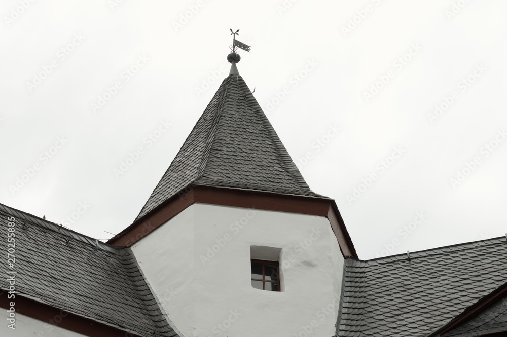 Black roof tiles of a white medieval building (Germany, Europe) Black roof tiles of a white medieval building (Germany, Europe)