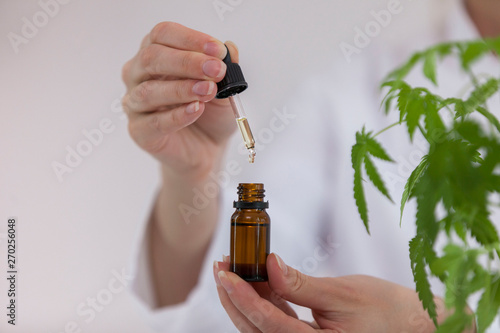 Scientist holding a bowl with cbd oil