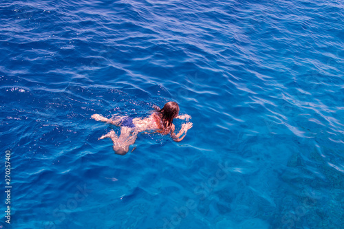 Snorkeling gear. Snorkeling girl in full face mask. Underwater swimming in Red sea near a coral reef. Tropical vacation activity snorkeling