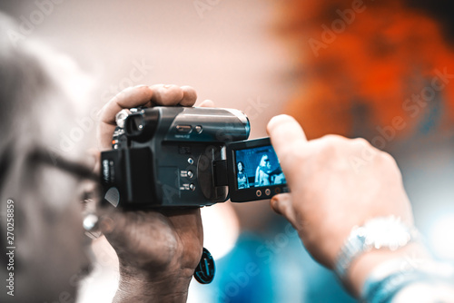 Man filming on video camera