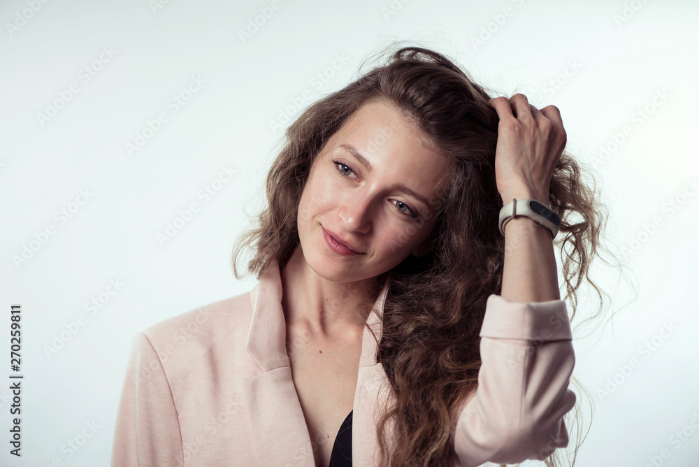 pretty stylish young girl model with long curly hair in a jacket on a white background pretty stylish young girl model with long curly hair in a jacket on a white background