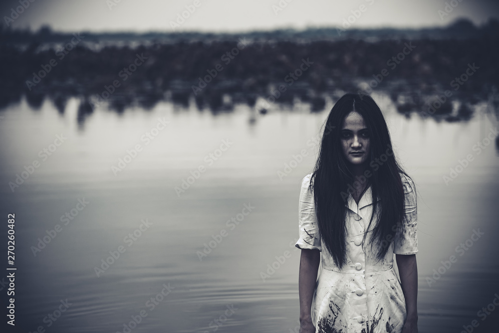 Portrait of asian woman make up ghost face at the swamp,Horror scene,Scary background,Halloween poster,Thailand people Portrait of asian woman make up ghost face at the swamp,Horror scene,Scary background,Halloween poster,Thailand people