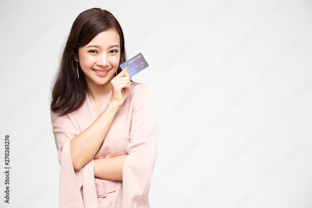 Happy Asian woman holding credit card or cash advances, Pay instead of money and specially curated benefits for lady card concept Happy Asian woman holding credit card or cash advances, Pay instead of money and specially curated benefits for lady card concept
