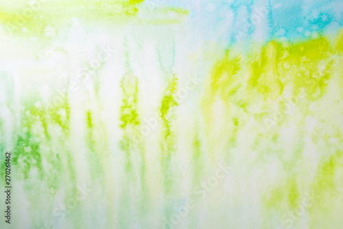 watercolor background filled green with blue wet paint drawing technique. on textured watercolor paper paint. wet paint drawing technique