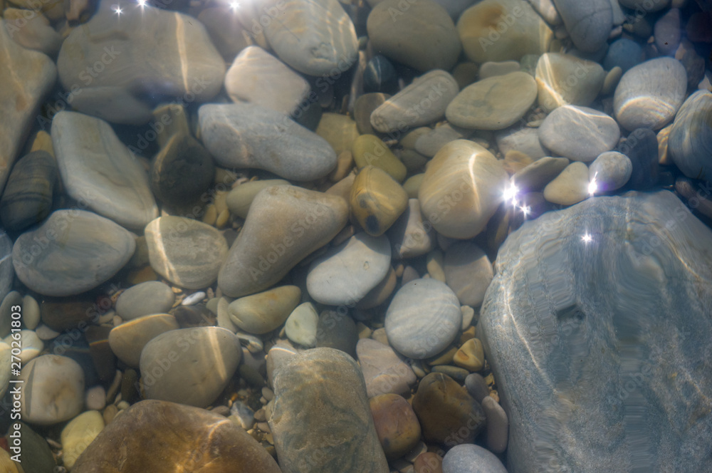 pebble stones on the sea beach, the rolling waves of the sea with foam pebble stones on the sea beach, the rolling waves of the sea with foam