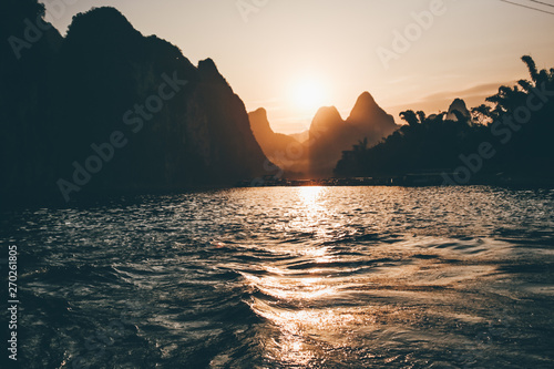 Li River at the sunset  Guilin - Yangshou China. Tilt shift panorama of the river from water.