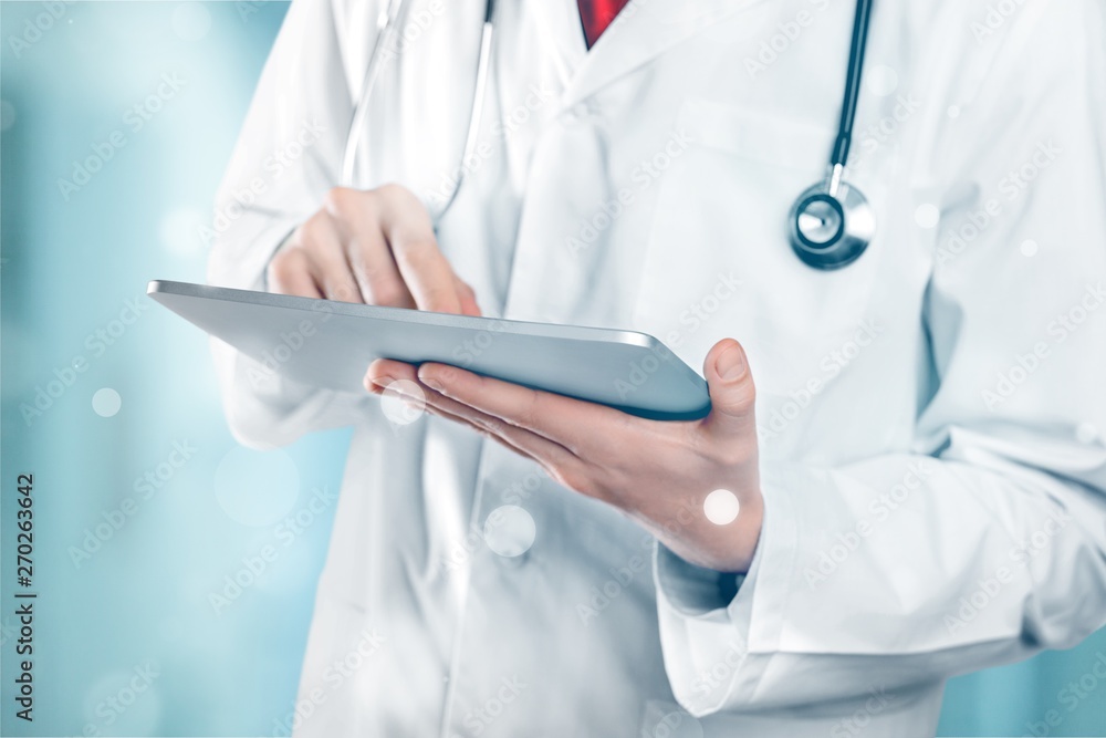 Close-up Doctor at hospital working with tablet pc Close-up Doctor at hospital working with tablet pc