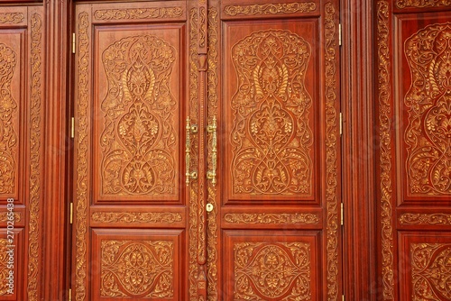 red yellow texture of the pattern on the old door with a door handle