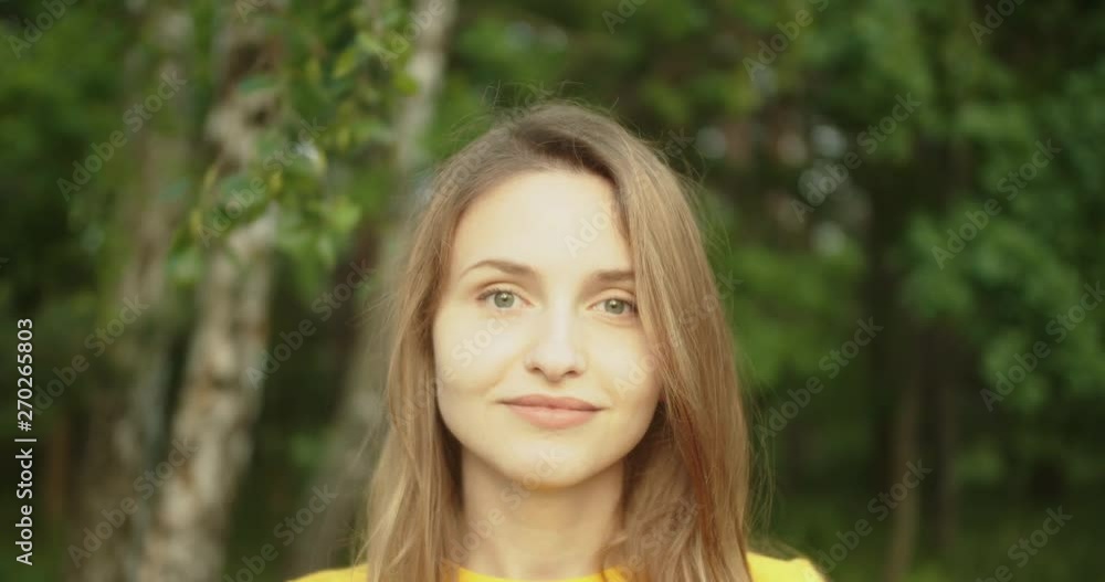 Beautiful girl front the camera with smile at nature close up Beautiful girl front the camera with smile at nature close up