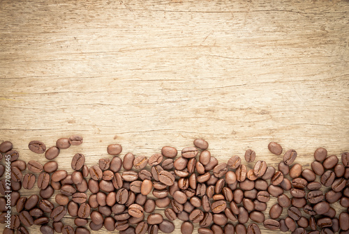 Coffee beans on old wood background © tendo23