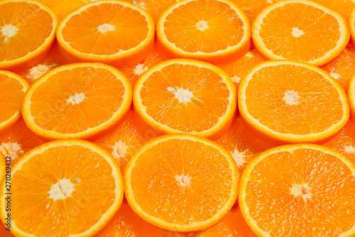 Slices of oranges as a background, top view.