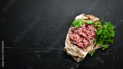 Minced meat on a black background. Top view. Free space for your text.