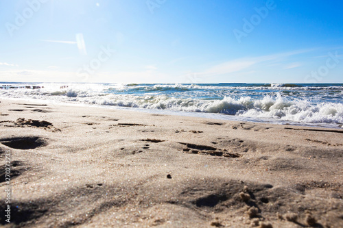 a beautiful wave hits the beach on a sandy beach on a Sunny day.