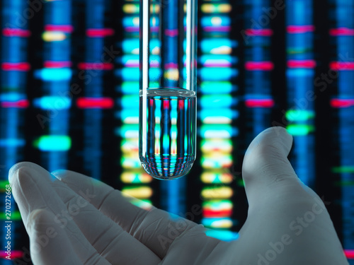 Genetic Research, DNA profile reflected in a test tube containing a sample