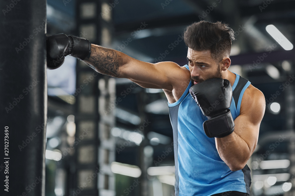 Young sportsman boxing workout at gym interior Young sportsman boxing workout at gym interior