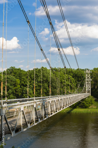 Side view on the suspension pedestrian bridge through the Neman River in the city Mosty, Republic of Belarus