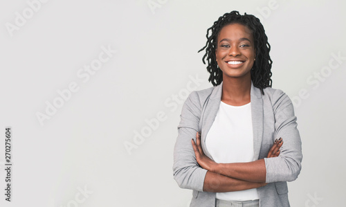 Successful African Businesswoman With Arms Crossed, Grey Background photo