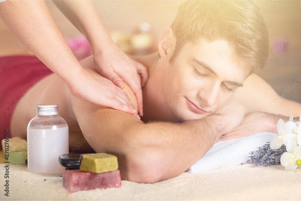 Young man having massage in spa salon Young man having massage in spa salon