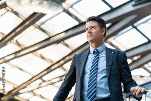 Wallpaper Mural Businessman with suitcase on escalator Torontodigital.ca