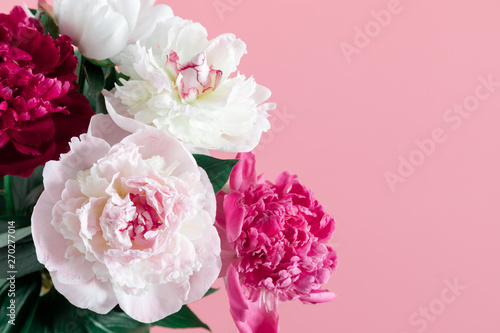 Beautiful peonies flowers on pastel pink background. Flat lay, top view, copy space