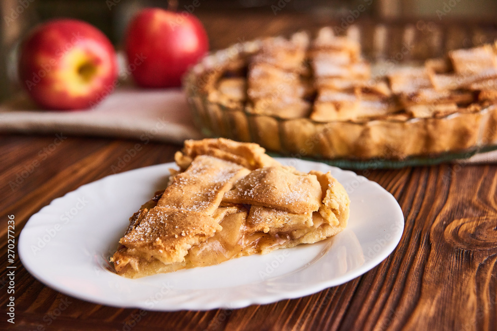 Apple autumn pie with cut slice on the plate on wooden background Apple autumn pie with cut slice on the plate on wooden background