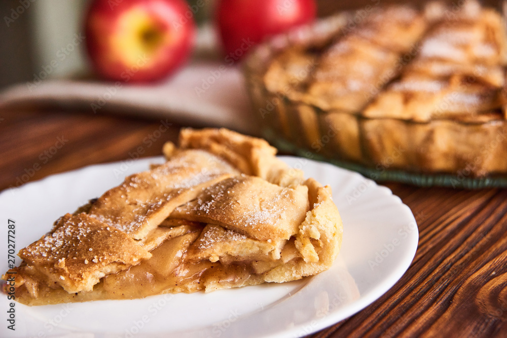 Apple autumn pie with cut slice on the plate on wooden background Apple autumn pie with cut slice on the plate on wooden background