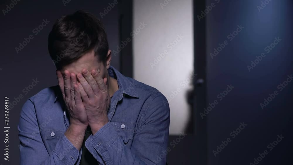 Depressed father crying in room, little daughter opening door, pain of loss Depressed father crying in room, little daughter opening door, pain of loss