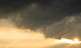Dramatic dark clouds on orange sky background and texture