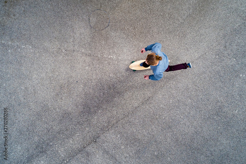 Overhead view of man skateboarding on road photo