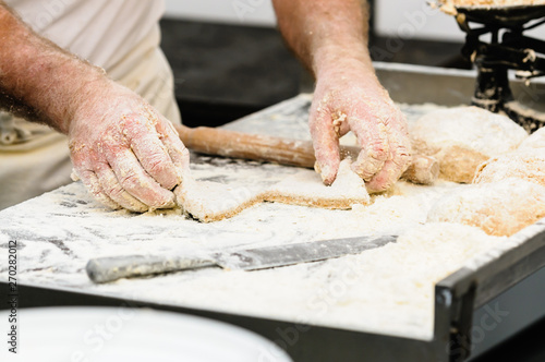 A man makes Irish traditional soda bread farls, common in most of Ireland, but particularly in Northern Ireland.