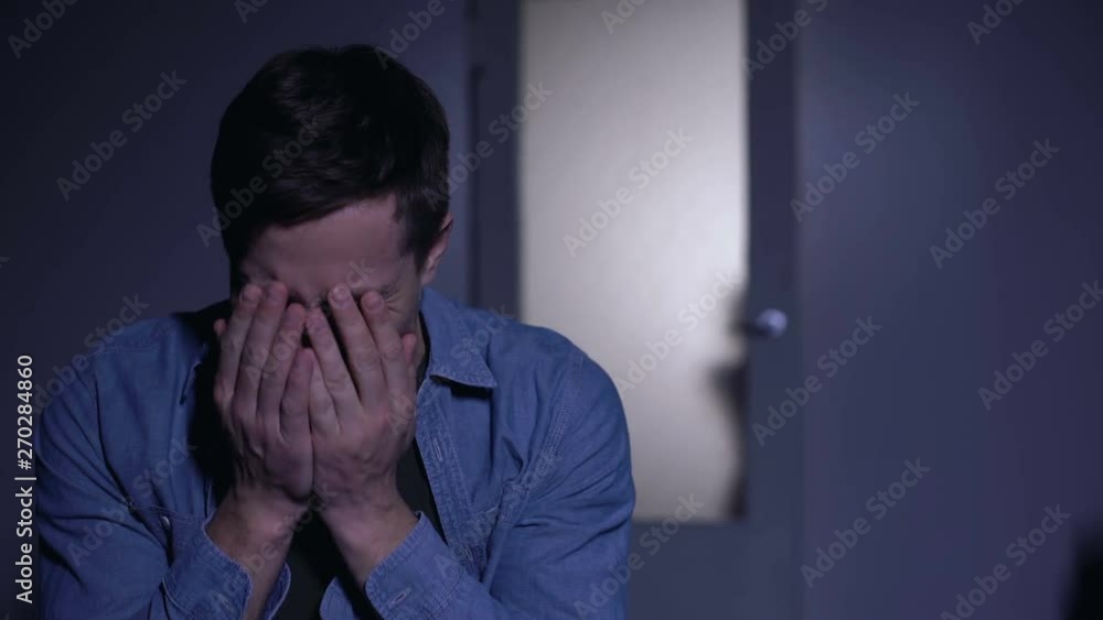 Sorrowful man crying in despair, little daughter comforting dad, family support Sorrowful man crying in despair, little daughter comforting dad, family support