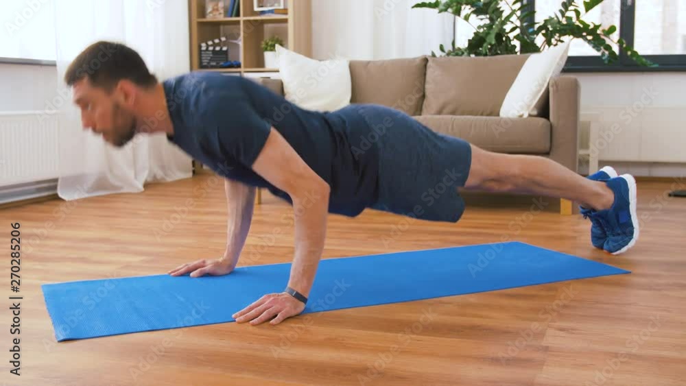 fitness, sport, training and concept - man doing push ups at home fitness, sport, training and concept - man doing push ups at home