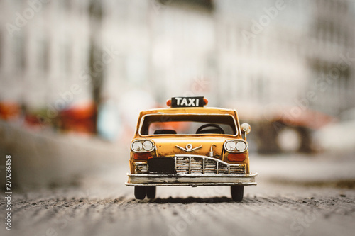 miniature yellow taxi cab on the street