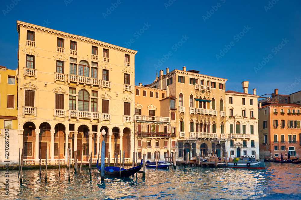 Old houses by Grand Canal in Venice, Italy, on a bright day
