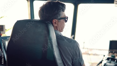 Marine navigational officer during navigational watch on Bridge . Work at sea photo