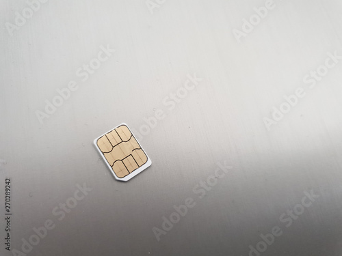 one micro sim card on a light background surface photo