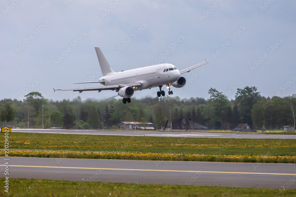 white passenger plane lands at the airport white passenger plane lands at the airport