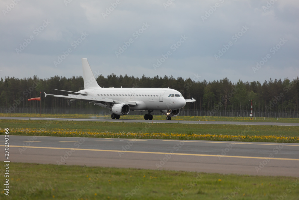 white passenger plane lands at the airport white passenger plane lands at the airport