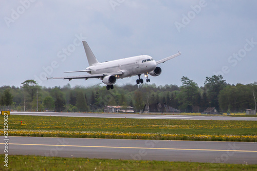 white passenger plane lands at the airport © Nikolai Tsvetkov
