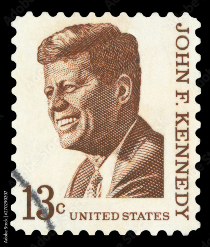 UNITED STATES OF AMERICA - CIRCA 1967: A used postage stamp printed in United States shows a portrait of the President John Fitzgerald Kennedy in brown, circa 1967. photo