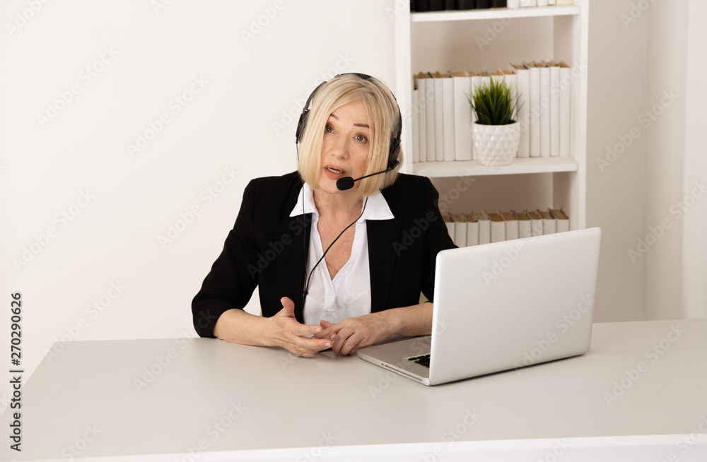 Female call center worker in office isolated on her workplace