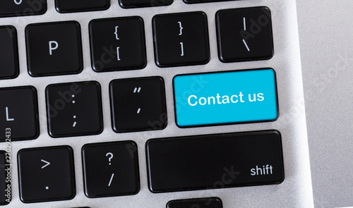 Valokuva Text Contact us on blue button of conputer keyboard