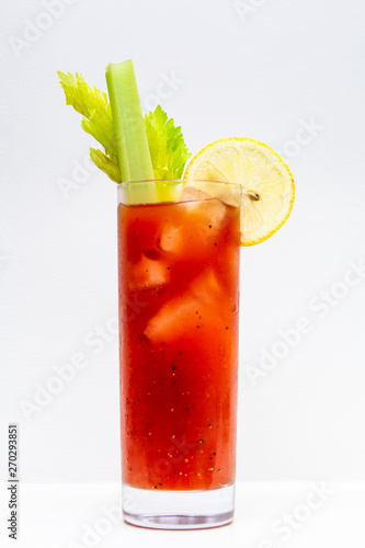 freshly made Bloody Mary cocktail or tomato juice, garnished with celery and lemon photo