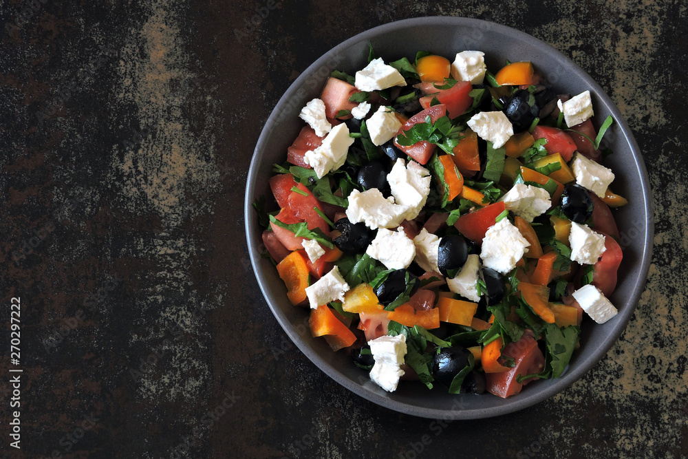 Fresh salad with vegetables, parsley and white cheese.